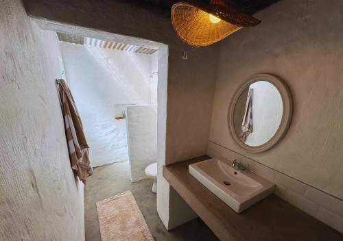a bathroom with a sink and a mirror at Fisherman's Cottages at Blombosch Game Farm in Yzerfontein