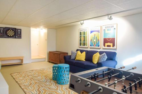 a living room with a blue couch and a table at Spacious Home by Beach Dog Welcome in Brewster