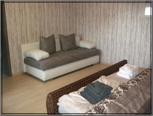 a living room with a couch and two pillows at Ferienwohnung Schäfer in Anschau
