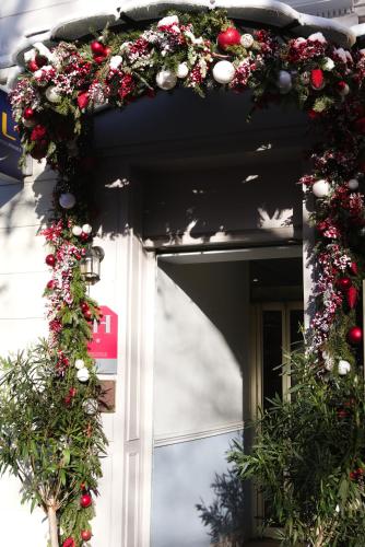 a door with a christmas wreath on it at Hôtel Regyn's Montmartre in Paris