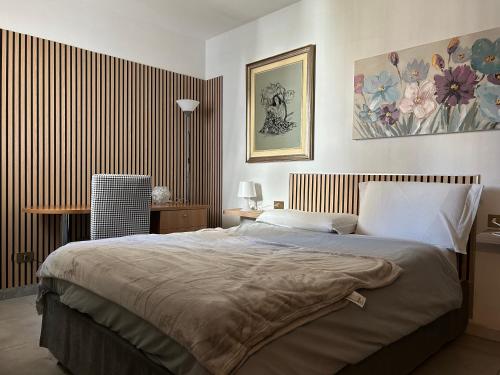 a bedroom with a large bed in a room at Grace 101 in Vigevano