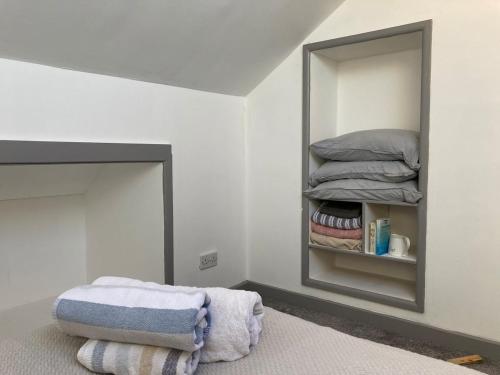 a bedroom with a mirror and a bed with towels at Skylight Loft, 2 bed apartment, central Lancaster in Lancaster