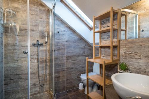a bathroom with a shower and a toilet and a sink at Chalupa Máša in Liptovský Trnovec
