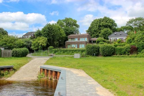 a house next to a river with a bridge at IDAHO - Deep in Süderstapel