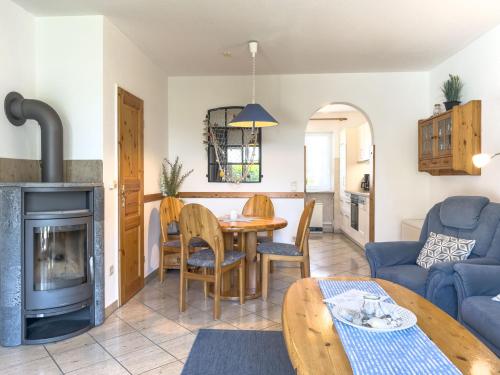 a living room with a table and a fireplace at Muschelsucher 2 in Nordstrand