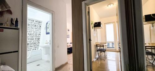 a door leading into a room with a table and chairs at Single room Perfect for single or couples! in Chiajna