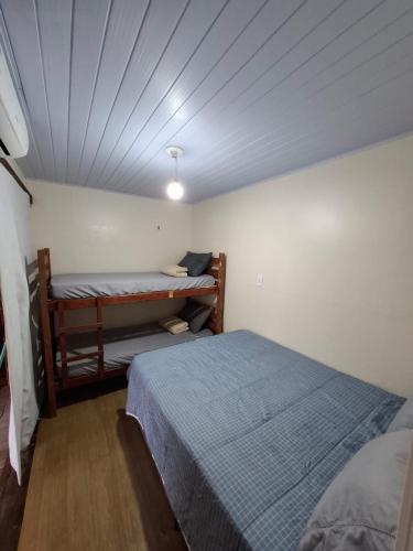a bedroom with two beds and a ceiling at Picco da Ilha Hostel in Florianópolis