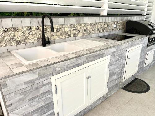 a kitchen with a sink and a counter top at Casa Roccella in Buonfornello