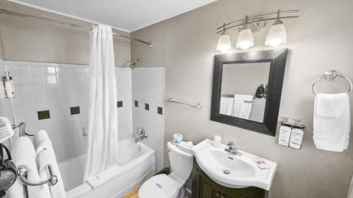 a bathroom with a sink and a toilet and a shower at Courtesy Inn Downtown Eugene in Eugene