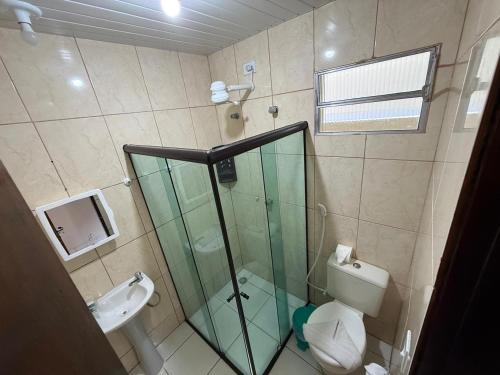 a bathroom with a shower and a toilet and a sink at Pousada Sal e Mar Maracaipe in Porto De Galinhas