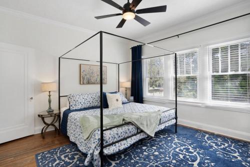 a bedroom with a canopy bed and a ceiling fan at Cruise the waterways from your backyard in Bradenton