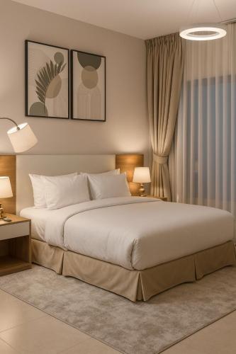 a bedroom with a large bed and two lamps at Prime Apartments Near WTC and Sheikh Zayed RD in Dubai