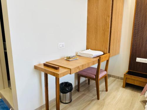 a wooden desk with a chair in a room at Hotel Valley in Akteshwar