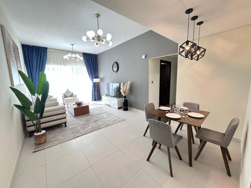 a dining room and living room with a table and chairs at Prime Apartments Near WTC and Sheikh Zayed RD in Dubai