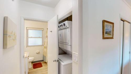 a white kitchen with a stove and a toilet at Atlantic Breeze #7 in Jekyll Island