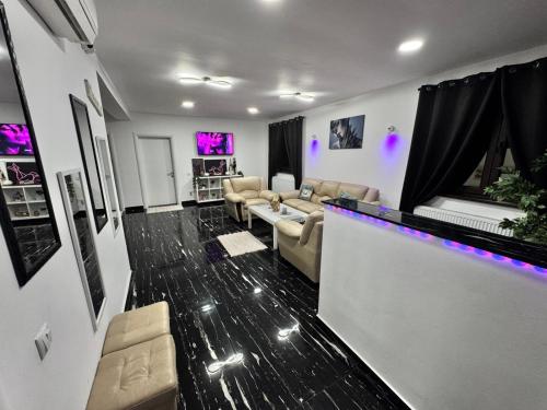 a living room with couches and a bar in a room at Enjoy VIP House 10 in Măgurele