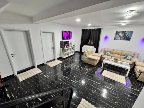 a living room with a couch and a table at Enjoy VIP House 10 in Măgurele