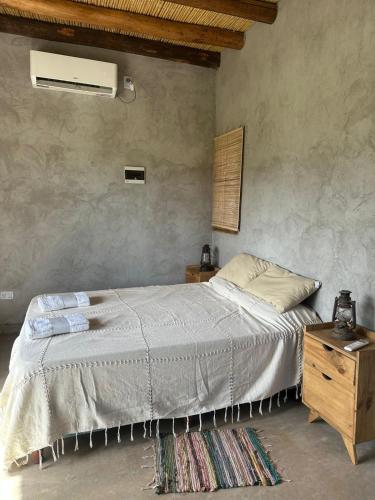 a bedroom with a bed and a wooden dresser at Capitan de Ansilta in Calingasta