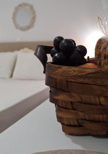 a basket of black grapes sitting on a table at Meltemaki in Mouzákion