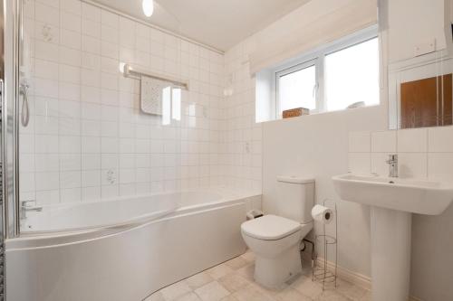 a white bathroom with a toilet and a sink at 3 Bed in Leyburn oc-ds013 in West Witton