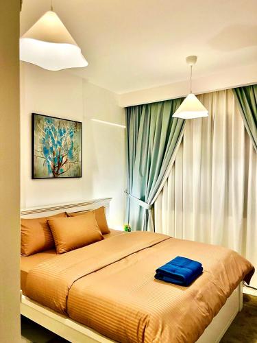 a bedroom with a bed with a blue suitcase on it at DSV Property in Abu Dhabi