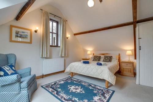 a bedroom with a bed and a chair at 2 Bed in Exminster oc-h28725 in Exminster