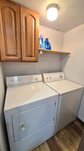 a white washer and dryer in a kitchen at Guys Getaway Cabin in Ruidoso