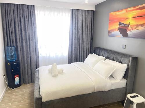 a bedroom with a large bed with a large window at Naisolas place in Marimbeti