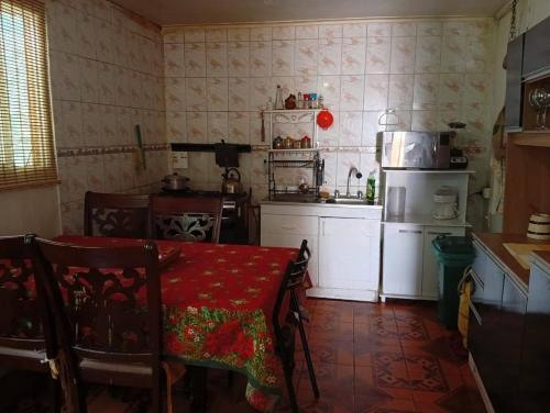 a kitchen with a table and a kitchen with a stove at Refugio Costero in Caldera