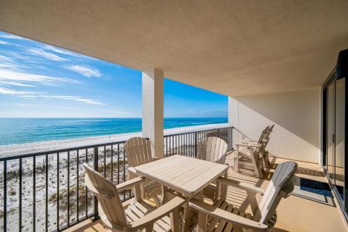 a balcony with a table and chairs and the ocean at Wind Drift 310S condo in Orange Beach
