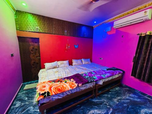 a bedroom with a bed in a colorful room at selvis casa in Pondicherry