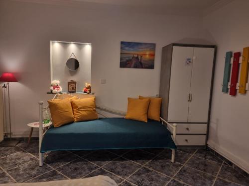 a bedroom with a bed with yellow and green pillows at Isthmus Cuddly Nest in Isthmia