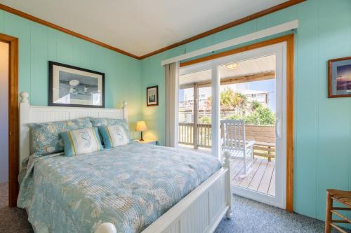 a bedroom with a bed and a balcony at Desi's Delight - S Nags Head MP 20.5, Ocean View, 30 Yards to Beach, Cargo Lift, YR Flex Stays in Nags Head