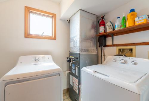 a small laundry room with a washer and dryer at Desi's Delight - S Nags Head MP 20.5, Ocean View, 30 Yards to Beach, Cargo Lift, YR Flex Stays in Nags Head