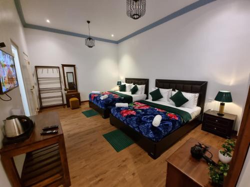 a living room with a bed and a couch at Astoria Cottage in Nuwara Eliya