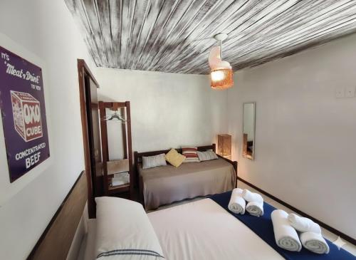a bedroom with two beds in a room at Gambá Casa Boutique in Búzios