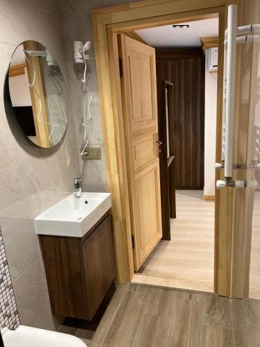 a bathroom with a sink and a mirror at Arkeon Bosphorus Hotel & Suites in Istanbul