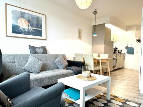a living room with a couch and a table at Ferienwohnung De Priel in Dorum-Neufeld