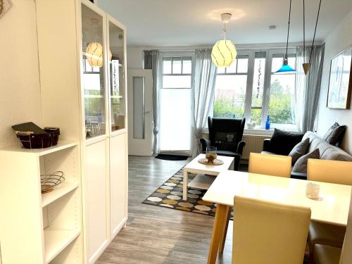 a living room with a couch and a table at Ferienwohnung De Priel in Dorum-Neufeld