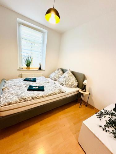 a bedroom with a bed and a window at Bright temporary apartment in Schkeuditz in Schkeuditz