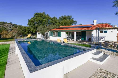 a swimming pool in the backyard of a house at Marvão Quinta da Bela Vista in Marvão