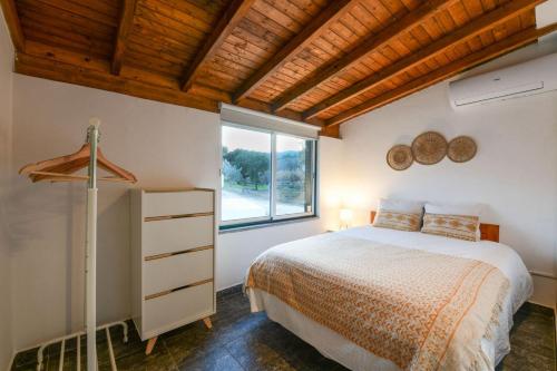 a bedroom with a bed and a window at Marvão Quinta da Bela Vista in Marvão