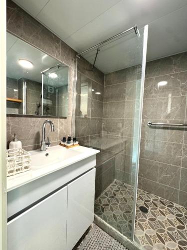 a bathroom with a white sink and a shower at גיל נכסים #2 in Caesarea