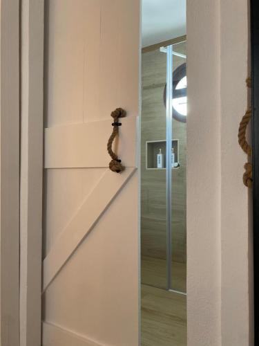 a hallway with a glass door leading to a stairway at Los Llanos del Campo in Grazalema