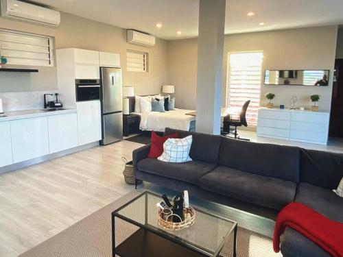 a large living room with a couch and a kitchen at Holiday Haven - Jan Thiel in Jan Thiel