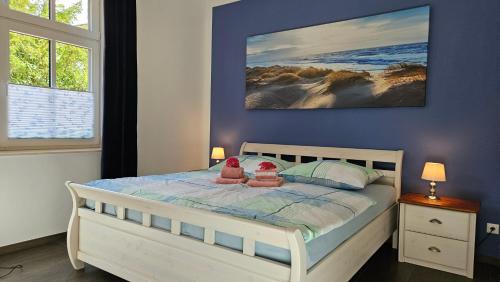 a bedroom with a bed with two shoes on it at Herrenhaus Darbein in Dargun