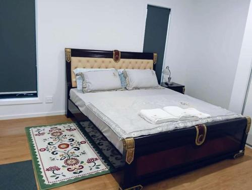 a bed in a bedroom with a rug on the floor at Northern Retreat in Wallan