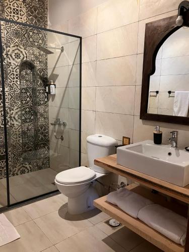a bathroom with a toilet and a sink and a shower at Sultana Palace in ‘Ezbet Abu Ḥabashi