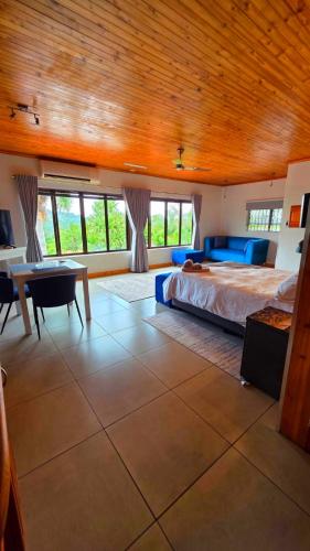 a large bedroom with a bed and a table at Rosies on Robin - Pool, Braai & Mountain Views in Rustenburg