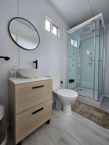 a bathroom with a sink and a toilet and a mirror at Maridalba 2 in La Coronilla